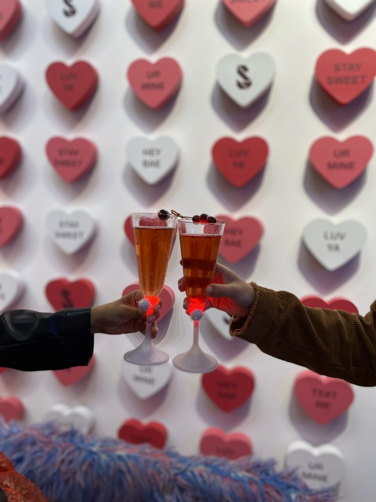 Toasting with drinks with hearts in the background
